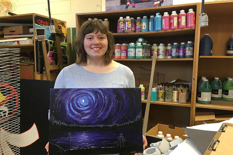 Art Assist- Junior Mary Brunn shows of one of her many art projects. Landscapes are Brunn's favorite thing to portray. 