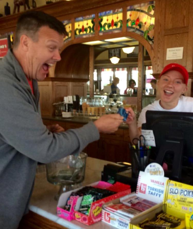 South Pier Parlor Employee Junior Madisyn Riste accepts Teacher Mr. Jon Schrank’s debit card as he pays for his delicious ice cream. The choice must have been difficult since the ice cream shop offers over 30 flavors!