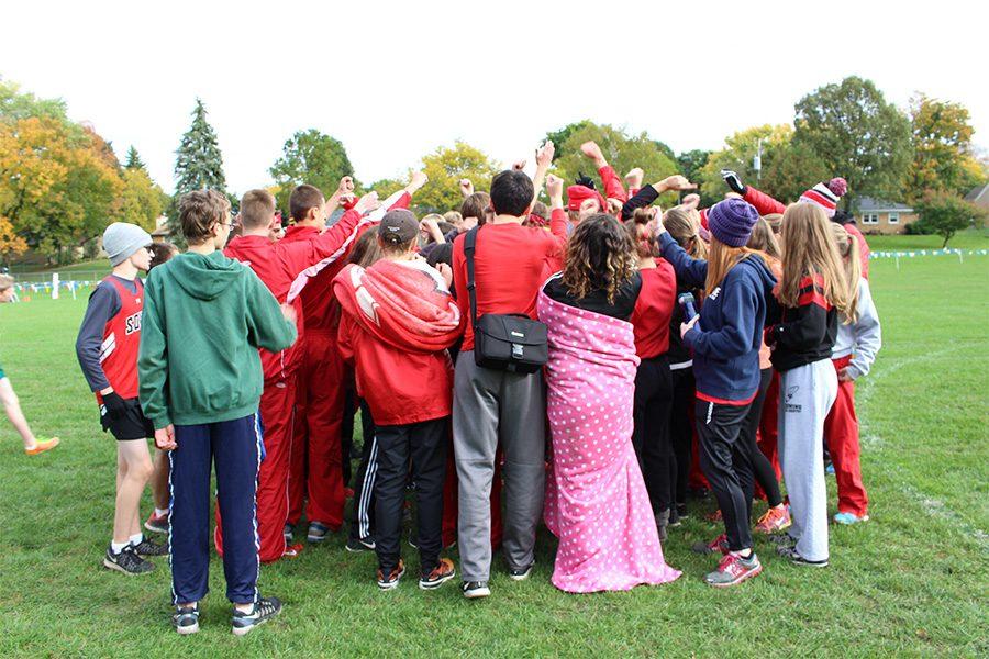 The Cross Country team breaks it down before beginning their race. The breakdowns were led by Senior Zachary Kaffine.