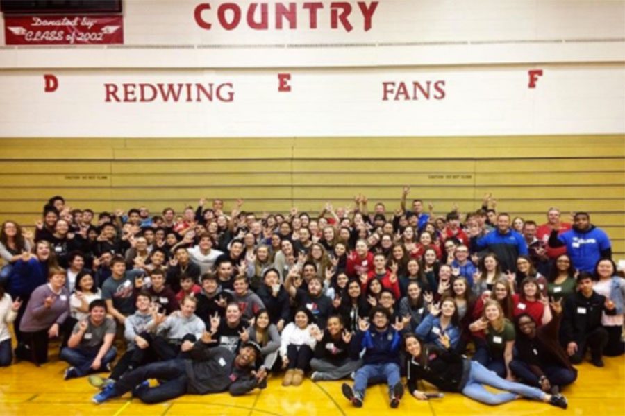 The group picture taken of all Challenge Day participants at South High School on Monday, December 5th. Participants held up the Challenge Day hand sign.