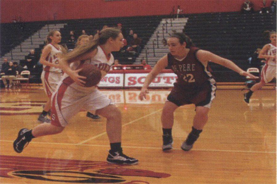 DRIBBLE-Two South High Redwings take on a De Pere Redbird. Finished in 2006, the Acuity Fieldhouse is used daily by Souths sports teams (2015 Lake Breeze yearbook).