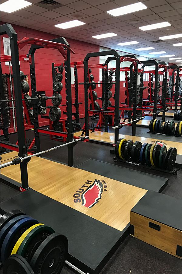 “NO DAYS OFF- During summer and after school, the South High fitness center is filled with students who want to improve their fitness. The racks are typically used for squats, cleans and bench press.