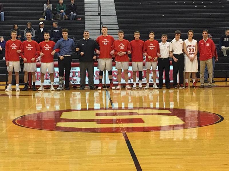 Dream Team- The basketball team poses with their Seniors after Senior night. Many of the boys have been playing together since they were young.