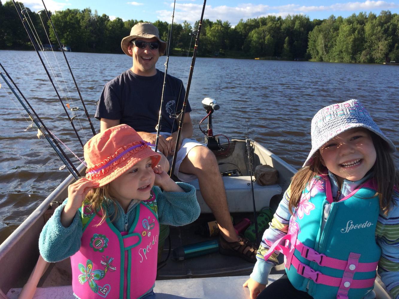Associative Principal Mr Kevin Formolo cheeses with his two little girls while fishing. Formolo said besides fishing, the girls like to