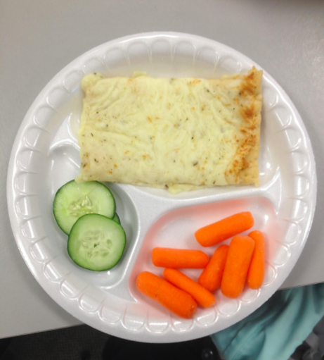 Here is an average 
day school lunch, 
consisting of
cucumbers, carrots,
and a cheesy pizza.