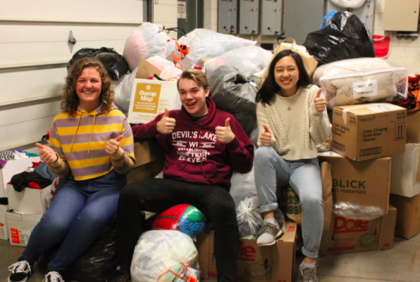 Senior Phillip Pethan along with fellow student council members Juniors Helen Flynn and Darahnea Moua smiling to show the appreciation of receiving such a large amount of clothes. 