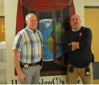 Officer Eirich (left) and Officer Friedl (right) pose for a photo. Their smiles are often seen through the hallways, and within the school.