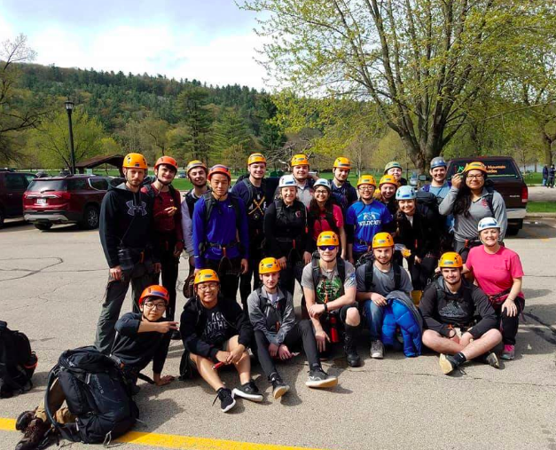 Students and chaperones, pose for a photo while getting ready to go rock climbing. They put this equipment on sponsored by adventure rock. 