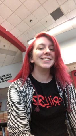 Senior Madison Samsal pictured looking cheerful with her red hair color. 
